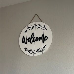 White and Black Circular Welcome Art Sign with Wreath Design